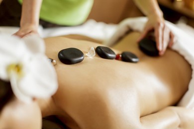 woman having hot stone massage in karachi142780858